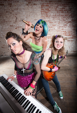 To use this stock image in your creative project, please select the size you need over to the right and click the "Add to Cart" button.
Your downloaded image will come with the Cutcaster watermark removed so don’t worry about the watermark you see on this page. Female punk rock band stock photo, Young all girl punk rock band performs in a warehouse by Scott Griessel