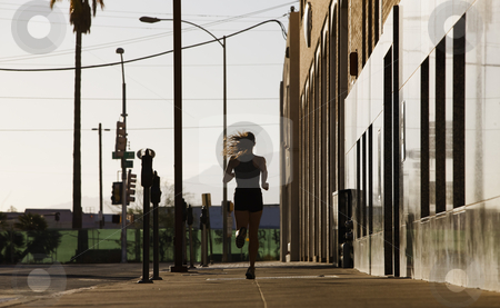 To use this stock image in your creative project, please select the size you need over to the right and click the "Add to Cart" button.
Your downloaded image will come with the Cutcaster watermark removed so don’t worry about the watermark you see on this page. Woman Out For A Morning Run Downtown stock photo, Woman running down a city block in the morning. by Scott Griessel