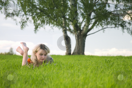 To use this stock image in your creative project, please select the size you need over to the right and click the "Add to Cart" button.
Your downloaded image will come with the Cutcaster watermark removed so don’t worry about the watermark you see on this page. Young beautiful woman lays on green field and reads stock photo, Young beautiful woman lays on green field and reads book. by Leonid Anfimov