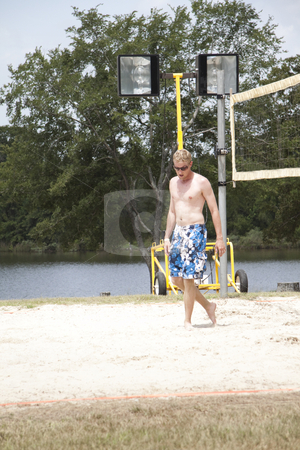 To use this stock image in your creative project, please select the size you need over to the right and click the "Add to Cart" button.
Your downloaded image will come with the Cutcaster watermark removed so don’t worry about the watermark you see on this page. Guy Walking stock photo, A guy walking on a sand volleyball court by Kevin Tietz