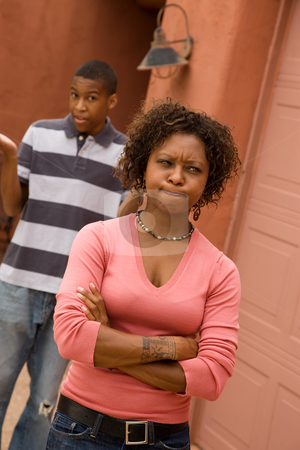 To use this stock image in your creative project, please select the size you need over to the right and click the "Add to Cart" button.
Your downloaded image will come with the Cutcaster watermark removed so don’t worry about the watermark you see on this page. African-American single-parent family stock photo, Frustrated single-mom and son outdoors in front of house by Scott Griessel