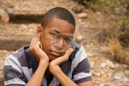 To use this stock image in your creative project, please select the size you need over to the right and click the "Add to Cart" button.
Your downloaded image will come with the Cutcaster watermark removed so don’t worry about the watermark you see on this page. Emotional male teen stock photo, Sad African-American Male sitting in outdoor setting by Scott Griessel