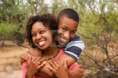 To use this stock image in your creative project, please select the size you need over to the right and click the "Add to Cart" button.
Your downloaded image will come with the Cutcaster watermark removed so don’t worry about the watermark you see on this page. Happy African-American family outside stock photo, Good-looking single-parent mom and son by Scott Griessel