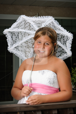 To use this stock image in your creative project, please select the size you need over to the right and click the "Add to Cart" button.
Your downloaded image will come with the Cutcaster watermark removed so don’t worry about the watermark you see on this page. Formal Child Portrait stock photo, A cute young girl, wearing a white dress and holding an umbrella is posing for her portrait by Richard Nelson