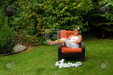 To use this stock image in your creative project, please select the size you need over to the right and click the "Add to Cart" button.
Your downloaded image will come with the Cutcaster watermark removed so don’t worry about the watermark you see on this page. Preteen Sitting Outside Portrait stock photo, A cute young girl, wearing a white dress is relaxing in the sun whilte sitting on a wicker chair outside. by Richard Nelson