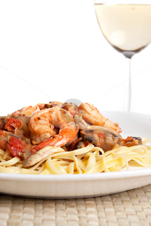 To use this stock image in your creative project, please select the size you need over to the right and click the "Add to Cart" button.
Your downloaded image will come with the Cutcaster watermark removed so don’t worry about the watermark you see on this page. Shrimp Scampi with Linguine stock photo, A delicious shrimp scampi over linguine dish along with a glass of pinot grigio white wine. by Todd Arena