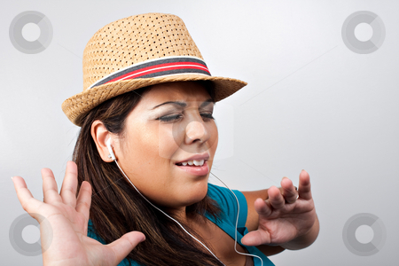 To use this stock image in your creative project, please select the size you need over to the right and click the "Add to Cart" button.
Your downloaded image will come with the Cutcaster watermark removed so don’t worry about the watermark you see on this page. Listening to Music stock photo, An attractive Hispanic woman listening to and getting into the music playing through her stereo ear bud headphones. by Todd Arena