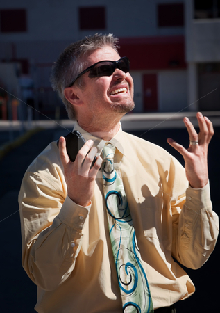 To use this stock image in your creative project, please select the size you need over to the right and click the "Add to Cart" button.
Your downloaded image will come with the Cutcaster watermark removed so don’t worry about the watermark you see on this page. Man screams in dispair over cell phone. stock photo, Man is frustrated with cell phone coverage. by Scott Griessel