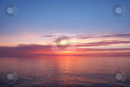 To use this stock image in your creative project, please select the size you need over to the right and click the "Add to Cart" button.
Your downloaded image will come with the Cutcaster watermark removed so don’t worry about the watermark you see on this page. Lake Superior Sunset stock photo, Beautiful pink colors reflect off Lake Superior in northern Michigan. by Jason Ross