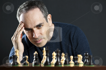 To use this stock image in your creative project, please select the size you need over to the right and click the "Add to Cart" button.
Your downloaded image will come with the Cutcaster watermark removed so don’t worry about the watermark you see on this page. Man playing chess stock photo, Chessboard with man thinking about chess strategy by Elena Elisseeva