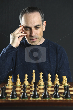 To use this stock image in your creative project, please select the size you need over to the right and click the "Add to Cart" button.
Your downloaded image will come with the Cutcaster watermark removed so don’t worry about the watermark you see on this page. Man playing chess stock photo, Man looking at wooden chess board thinking about first move by Elena Elisseeva