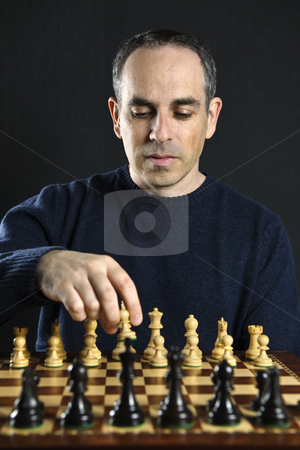To use this stock image in your creative project, please select the size you need over to the right and click the "Add to Cart" button.
Your downloaded image will come with the Cutcaster watermark removed so don’t worry about the watermark you see on this page. Man playing chess stock photo, Man moving a chess piece on wooden chessboard by Elena Elisseeva