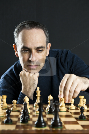 To use this stock image in your creative project, please select the size you need over to the right and click the "Add to Cart" button.
Your downloaded image will come with the Cutcaster watermark removed so don’t worry about the watermark you see on this page. Man playing chess stock photo, Man moving a chess piece on wooden chessboard by Elena Elisseeva