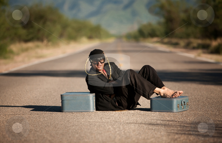 To use this stock image in your creative project, please select the size you need over to the right and click the "Add to Cart" button.
Your downloaded image will come with the Cutcaster watermark removed so don’t worry about the watermark you see on this page. Strange indigenous man in the middle of a road stock photo, Strange indigenous man in the middle of a road with suitcases by Scott Griessel