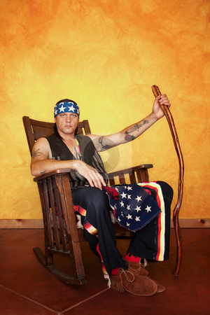 To use this stock image in your creative project, please select the size you need over to the right and click the "Add to Cart" button.
Your downloaded image will come with the Cutcaster watermark removed so don’t worry about the watermark you see on this page. Native American man stock photo, Kneeling Native American man in rocking chair by Scott Griessel