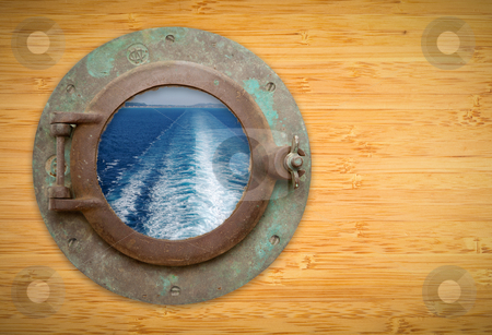 To use this stock image in your creative project, please select the size you need over to the right and click the "Add to Cart" button.
Your downloaded image will come with the Cutcaster watermark removed so don’t worry about the watermark you see on this page. Antique Porthole on Bamboo Wall with View of Ship Ocean Trail stock photo, Antique Porthole on Bamboo Wall with View of Ship Wave Trail, Land and Sky. by Andy Dean