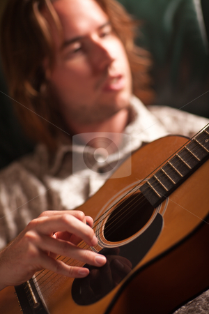 To use this stock image in your creative project, please select the size you need over to the right and click the "Add to Cart" button.
Your downloaded image will come with the Cutcaster watermark removed so don’t worry about the watermark you see on this page. Young Musician Plays His Acoustic Guitar stock photo, Young Musician Plays His Acoustic Guitar under Dramatic Lighting. by Andy Dean