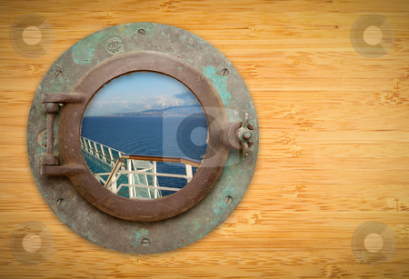 To use this stock image in your creative project, please select the size you need over to the right and click the "Add to Cart" button.
Your downloaded image will come with the Cutcaster watermark removed so don’t worry about the watermark you see on this page. Antique Porthole on Bamboo Wall with View of Ship Deck Railing a stock photo, Antique Porthole on Bamboo Wall with View of Ship Deck Railing, Ocean, Land and Sky. by Andy Dean