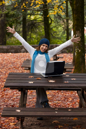 To use this stock image in your creative project, please select the size you need over to the right and click the "Add to Cart" button.
Your downloaded image will come with the Cutcaster watermark removed so don’t worry about the watermark you see on this page. Happy work stock photo, Beautiful and happy young woman in the park in front of a laptop by ikostudio