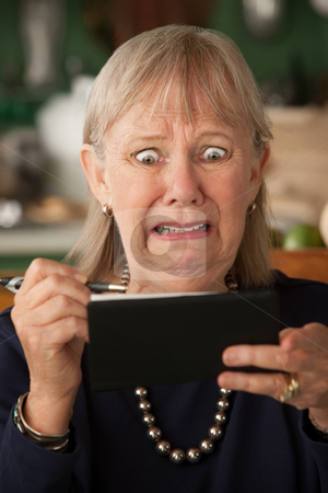 To use this stock image in your creative project, please select the size you need over to the right and click the "Add to Cart" button.
Your downloaded image will come with the Cutcaster watermark removed so don’t worry about the watermark you see on this page. Senior woman with checkbook stock photo, Senior woman at home with checkbook by Scott Griessel
