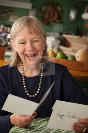 To use this stock image in your creative project, please select the size you need over to the right and click the "Add to Cart" button.
Your downloaded image will come with the Cutcaster watermark removed so don’t worry about the watermark you see on this page. Senior woman with greeting card stock photo, Senior woman at home reading greeting card by Scott Griessel