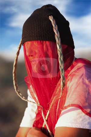 To use this stock image in your creative project, please select the size you need over to the right and click the "Add to Cart" button.
Your downloaded image will come with the Cutcaster watermark removed so don’t worry about the watermark you see on this page. Man with strange headdress and veil stock photo, Man with strange headdress and red veil by Scott Griessel