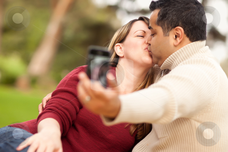 To use this stock image in your creative project, please select the size you need over to the right and click the "Add to Cart" button.
Your downloaded image will come with the Cutcaster watermark removed so don’t worry about the watermark you see on this page. Attractive Mixed Race Couple Taking Self Portraits stock photo, Attractive Mixed Race Couple Taking Self Portraits in the Park. by Andy Dean