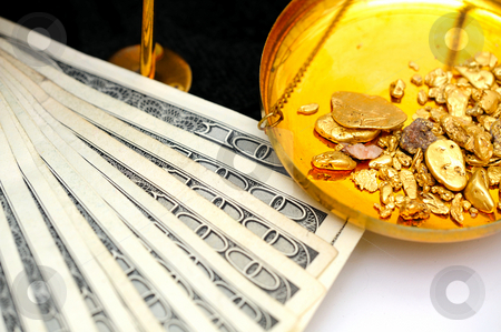To use this stock image in your creative project, please select the size you need over to the right and click the "Add to Cart" button.
Your downloaded image will come with the Cutcaster watermark removed so don’t worry about the watermark you see on this page. Raw Gold And Money stock photo, Gold nuggets in the pan of a balance scale with many fifty and hundred dollar bills showing the value of both by Lynn Bendickson