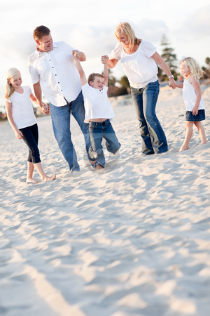 To use this stock image in your creative project, please select the size you need over to the right and click the "Add to Cart" button.
Your downloaded image will come with the Cutcaster watermark removed so don’t worry about the watermark you see on this page. Happy Young Boy Swinging with His Parents stock photo, Happy Young Boy Swinging with His Parents and Family at the Beach. by Andy Dean