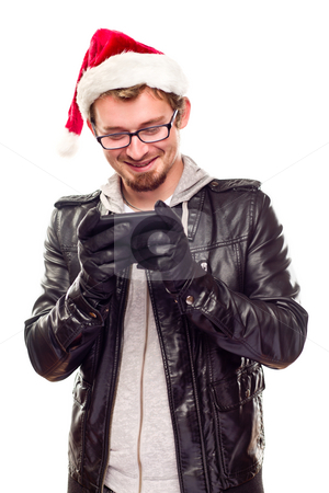 To use this stock image in your creative project, please select the size you need over to the right and click the "Add to Cart" button.
Your downloaded image will come with the Cutcaster watermark removed so don’t worry about the watermark you see on this page. Young Man with Santa Hat Using Cell Phone stock photo, Smiling Young Man with Santa Hat Using Cell Phone Isolated on a White Background. by Andy Dean