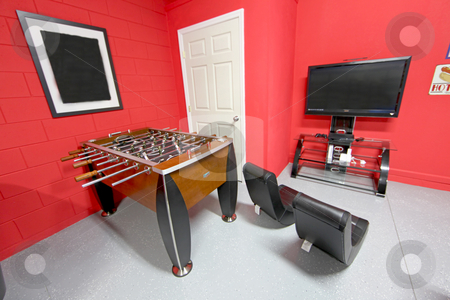 To use this stock image in your creative project, please select the size you need over to the right and click the "Add to Cart" button.
Your downloaded image will come with the Cutcaster watermark removed so don’t worry about the watermark you see on this page. Games Room stock photo, A Games Room with Foosball, TV and Gaming Chairs by Lucy Clark
