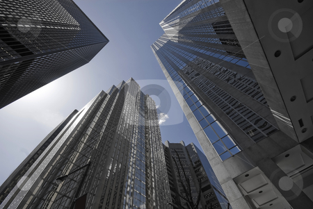 To use this stock image in your creative project, please select the size you need over to the right and click the "Add to Cart" button.
Your downloaded image will come with the Cutcaster watermark removed so don’t worry about the watermark you see on this page. Blue Grey Offices stock photo, A group of soaring office towers, shaded in blue and grey. by Mary Lane