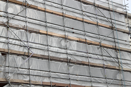 To use this stock image in your creative project, please select the size you need over to the right and click the "Add to Cart" button.
Your downloaded image will come with the Cutcaster watermark removed so don’t worry about the watermark you see on this page. Building covered in scaffolding and tarpaulin for renovation. stock photo, Building covered in scaffolding and tarpaulin for renovation. by Stephen Rees