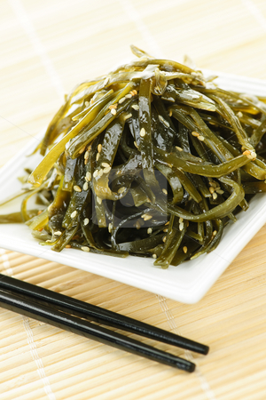 To use this stock image in your creative project, please select the size you need over to the right and click the "Add to Cart" button.
Your downloaded image will come with the Cutcaster watermark removed so don’t worry about the watermark you see on this page. Seaweed salad stock photo, Plate of wakame seaweed salad with chopsticks by Elena Elisseeva