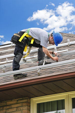 To use this stock image in your creative project, please select the size you need over to the right and click the "Add to Cart" button.
Your downloaded image will come with the Cutcaster watermark removed so don’t worry about the watermark you see on this page. Man working on roof installing rails for solar panels stock photo, Man installing rails for solar panels on residential house roof by Elena Elisseeva