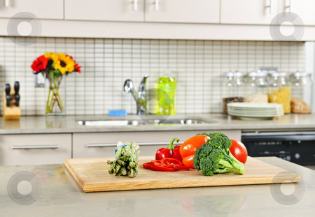 To use this stock image in your creative project, please select the size you need over to the right and click the "Add to Cart" button.
Your downloaded image will come with the Cutcaster watermark removed so don’t worry about the watermark you see on this page. Kitchen interior stock photo, Modern kitchen interior with fresh vegetables on natural stone countertop by Elena Elisseeva