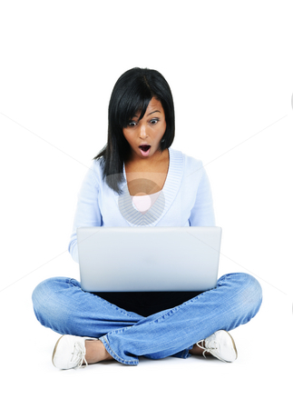 To use this stock image in your creative project, please select the size you need over to the right and click the "Add to Cart" button.
Your downloaded image will come with the Cutcaster watermark removed so don’t worry about the watermark you see on this page. Young woman with computer stock photo, Surprised black woman sitting with computer isolated on white background by Elena Elisseeva