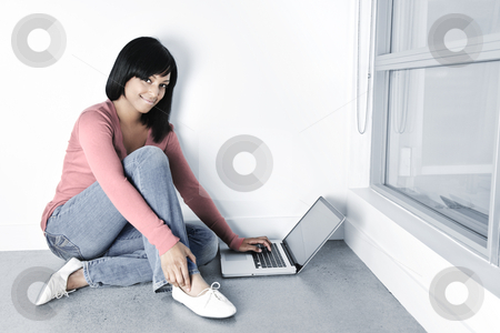 To use this stock image in your creative project, please select the size you need over to the right and click the "Add to Cart" button.
Your downloaded image will come with the Cutcaster watermark removed so don’t worry about the watermark you see on this page. Young woman using laptop computer on floor stock photo, Young black woman with laptop computer sitting on floor smiling by Elena Elisseeva