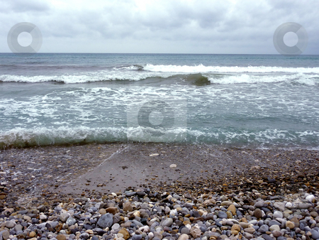 To use this stock image in your creative project, please select the size you need over to the right and click the "Add to Cart" button.
Your downloaded image will come with the Cutcaster watermark removed so don’t worry about the watermark you see on this page. Beach and waves stock photo, Mediterranean sea and its waves at a beach with lots of pebbles and small brown and grey stone, by cloudy weather by Elenarts