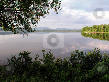 To use this stock image in your creative project, please select the size you need over to the right and click the "Add to Cart" button.
Your downloaded image will come with the Cutcaster watermark removed so don’t worry about the watermark you see on this page. Beautiful and calm lake stock photo, Beautiful Landscape of calm lake in Sweden by Sasas Design