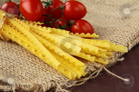 To use this stock image in your creative project, please select the size you need over to the right and click the "Add to Cart" button.
Your downloaded image will come with the Cutcaster watermark removed so don’t worry about the watermark you see on this page. Italian pasta on a wooden board wish tomato stock photo, by Olga Kriger