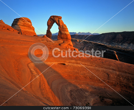 To use this stock image in your creative project, please select the size you need over to the right and click the "Add to Cart" button.
Your downloaded image will come with the Cutcaster watermark removed so don’t worry about the watermark you see on this page. Delicate Arch stock photo, Delicate Arch in Arches National Park, Utah. by Mike Norton