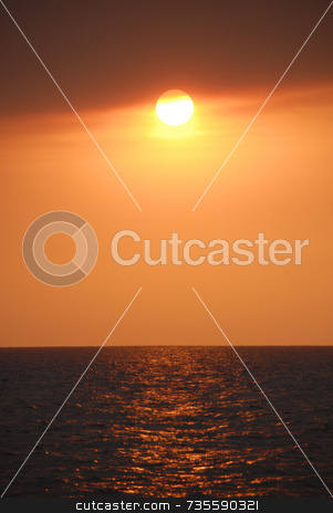 To use this stock image in your creative project, please select the size you need over to the right and click the "Add to Cart" button.
Your downloaded image will come with the Cutcaster watermark removed so don’t worry about the watermark you see on this page. Fire Sunset over Ocean stock photo, Orange sun over ocean by A Cotton Photo