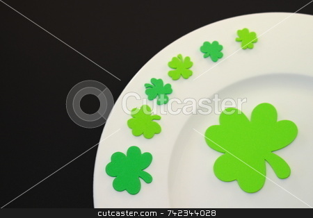 To use this stock image in your creative project, please select the size you need over to the right and click the "Add to Cart" button.
Your downloaded image will come with the Cutcaster watermark removed so don’t worry about the watermark you see on this page. St. Patrick's Day Plate stock photo, White plate on black background with green clover leafs. by Henrik Lehnerer
