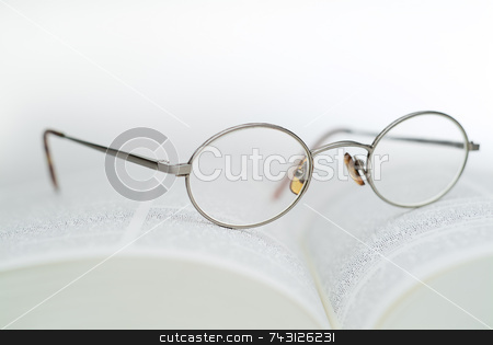 To use this stock image in your creative project, please select the size you need over to the right and click the "Add to Cart" button.
Your downloaded image will come with the Cutcaster watermark removed so don’t worry about the watermark you see on this page. Book and reading glasses stock photo, High key closeup of reading glasses on an open book by Vince Clements