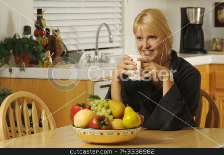 To use this stock image in your creative project, please select the size you need over to the right and click the "Add to Cart" button.
Your downloaded image will come with the Cutcaster watermark removed so don’t worry about the watermark you see on this page. Woman with Cup of Coffee in Kitchen Smiling stock photo, Beautiful young successful woman, enjoying a cup of coffee in her home. by Andy Dean
