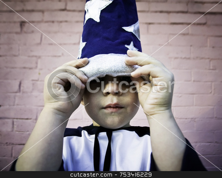 To use this stock image in your creative project, please select the size you need over to the right and click the "Add to Cart" button.
Your downloaded image will come with the Cutcaster watermark removed so don’t worry about the watermark you see on this page. Boy looking out from a wizard hat stock photo, Young boy lifts the brim of a wizard hat and peers out. by Scott Griessel