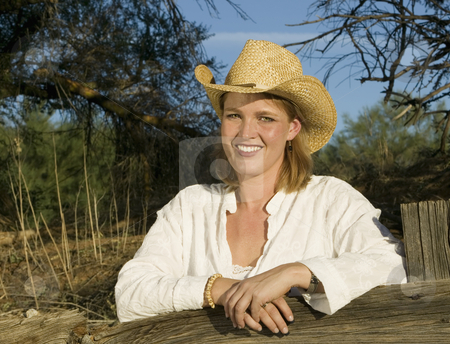To use this stock image in your creative project, please select the size you need over to the right and click the "Add to Cart" button.
Your downloaded image will come with the Cutcaster watermark removed so don’t worry about the watermark you see on this page. Western Woman stock photo, Western woman leans against a decrepit old split rail fence. by Scott Griessel