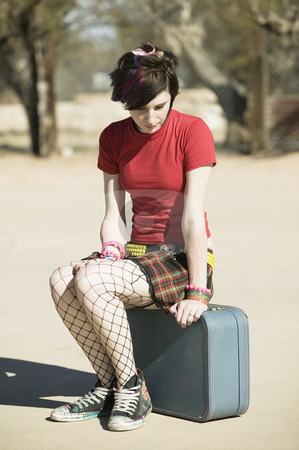 To use this stock image in your creative project, please select the size you need over to the right and click the "Add to Cart" button.
Your downloaded image will come with the Cutcaster watermark removed so don’t worry about the watermark you see on this page. Punk Girl Sitting on Suitcase stock photo, Punk Girl Sitting on a Suitcase on a Cement Playground by Scott Griessel