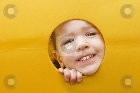 To use this stock image in your creative project, please select the size you need over to the right and click the "Add to Cart" button.
Your downloaded image will come with the Cutcaster watermark removed so don’t worry about the watermark you see on this page. Little girls face through a hole in play equipment stock photo, A little girl sticks her face through a hole in a yellow plastic piece of playground equipment by Scott Griessel